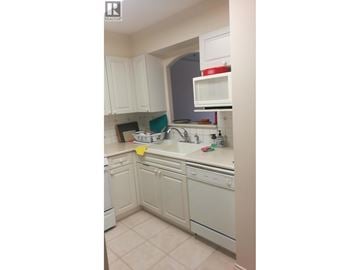 Vancouver apartment for rent - A kitchen with white cabinets and appliances.