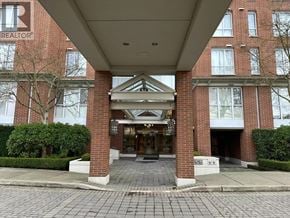 Vancouver apartment for rent - A building entrance with a brick facade and a glass door.