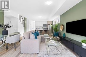 Toronto (Dufferin Grove) fourplex for rent - A modern living room with a glass table and grey couch.