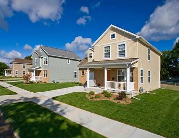 Detroit apartment for rent - A house with a well-maintained lawn and a clear sky.