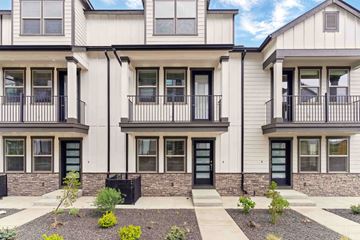 Bend apartment for rent - A row of modern townhouses with black railings and doors.