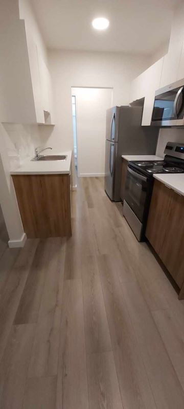 Halifax apartment for rent - A kitchen with a refrigerator, microwave, and oven.