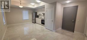 Aurora (Aurora Village) multi-family for rent - A spacious kitchen with white appliances and a white door.