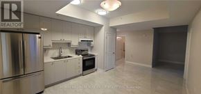 Aurora (Aurora Village) multi-family for rent - A kitchen with a refrigerator, oven, and sink.