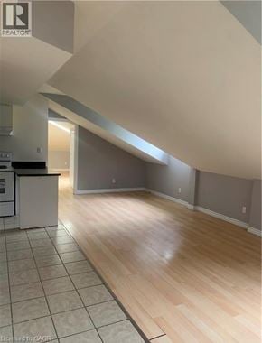 Dundas apartment for rent - A kitchen with a white refrigerator and wooden floors.