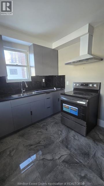 Windsor house for rent - A kitchen with a black stove top oven.