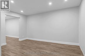 Hamilton (Gibson) house for rent - A room with wooden flooring and white walls, with a logo for REALTOR in the top left corner.