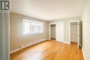 Ottawa multi-family for rent - A kitchen with a stove and a ceiling fan.