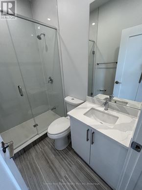 Toronto (Church-Yonge Corridor) multi-family for rent - A white toilet sits next to a sink in a bathroom.