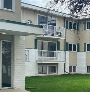 Edmonton apartment for rent - A white and beige building with a balcony.