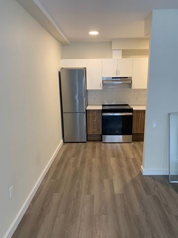 Halifax apartment for rent - A kitchen with a stainless steel refrigerator and wooden flooring.
