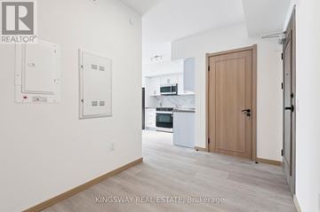Toronto (Tam O'shanter-Sullivan) condo for rent - A kitchen area with a refrigerator, oven, and sink.