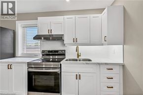 Hamilton apartment for rent - A modern kitchen with white cabinets and stainless steel appliances.
