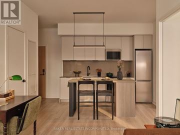 Toronto (Waterfront Communities) condo for rent - A modern living room with a green sofa and a wooden coffee table.