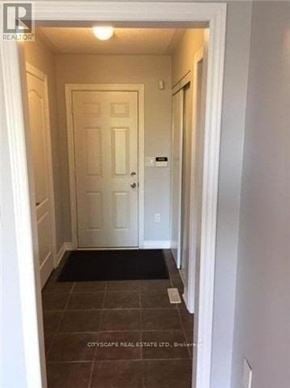 Mississauga (Churchill Meadows) house for rent - A hallway with a door and a mat on the floor.
