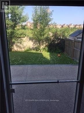 Mississauga (Churchill Meadows) house for rent - A view from a window looking out to a backyard.