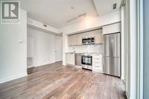 Toronto (Church-Yonge Corridor) condo for rent - A kitchen with a microwave and oven built into the cabinetry.
