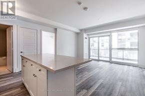 Innisfil condo for rent - A spacious kitchen with a large island and sliding glass doors.