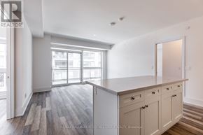 Innisfil condo for rent - A spacious kitchen with a large island and a view of the city.