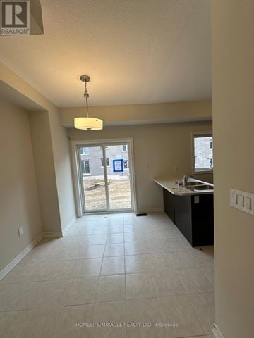 Brantford townhouse for rent - A realtor photo of a kitchen area with a sink and a window.