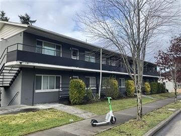 Seattle apartment for rent - A scooter is parked on the sidewalk in front of a building.
