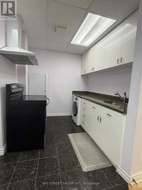 Richmond Hill (Rouge Woods) house for rent - A realtor's office with a black couch and a painting on the wall.