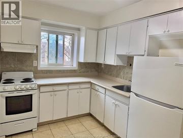 Windsor apartment for rent - A kitchen with white appliances and cabinets.