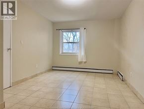 Windsor apartment for rent - A room with a window and a door.