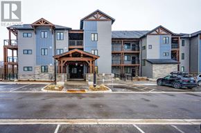 Blue Mountains condo for rent - A large, modern apartment complex with a central entrance and a car parked in front.