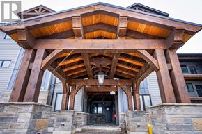 Blue Mountains condo for rent - A wooden entrance with a black door and a stone wall.