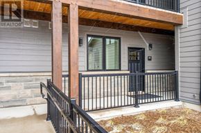 Blue Mountains condo for rent - A house with a wooden porch and black railings.