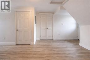 Hamilton house for rent - A room with two doors and a wooden floor.