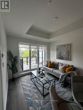 Toronto (Beechborough-Greenbrook) condo for rent - A living room with a couch, a coffee table, and a painting on the wall.