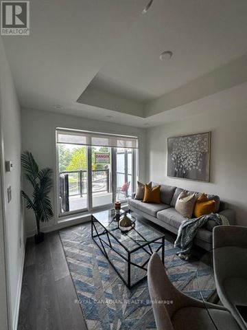 Toronto (Beechborough-Greenbrook) condo for rent - A living room with a couch, a coffee table, and a painting on the wall.