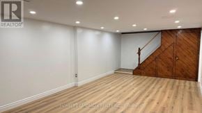 Toronto (Agincourt South-Malvern West) house for rent - A room with wooden flooring and a staircase on one side.