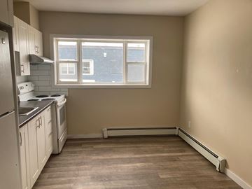 North Bay apartment for rent - A kitchen with a window and a stove top oven.