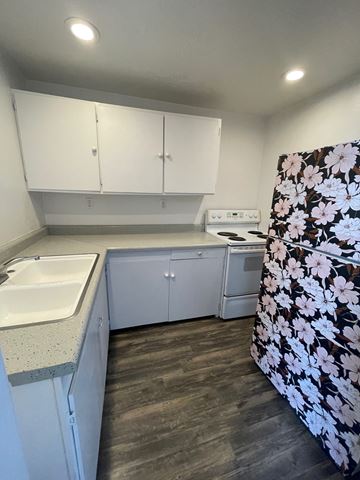 Clearfield apartment for rent - A kitchen with white cabinets and a floral refrigerator.