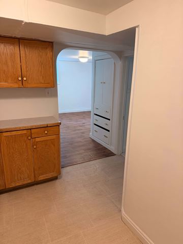 Salt Lake City apartment for rent - A kitchen with wooden cabinets and a white countertop.