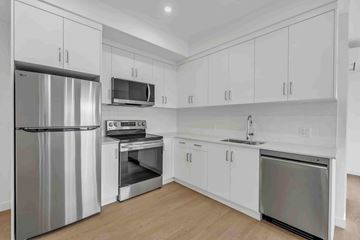 Penticton apartment for rent - A kitchen with white cabinets and stainless steel appliances.