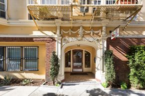 San Francisco apartment for rent - A building with a yellow facade and a white door.