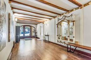 San Francisco apartment for rent - A long hallway with a bench and a mirror on the wall.
