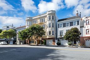 San Francisco apartment for rent - A street view of a residential area with houses and trees.