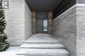 Ottawa house for rent - A house entrance with a stone wall and a glass door.