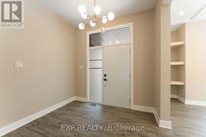 Ottawa house for rent - A room with a white door and a chandelier hanging from the ceiling.