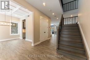 Ottawa house for rent - A spacious hallway with a staircase leading to the second floor.