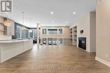 Ottawa house for rent - A spacious living room with a fireplace and a dining area with a table and chairs.