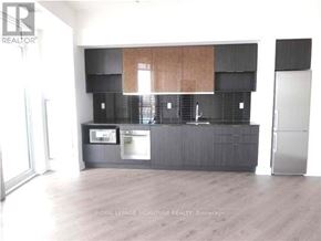 Toronto (Banbury-Don Mills) condo for rent - A kitchen with a refrigerator, microwave, and oven.
