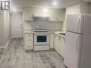 Brampton (Northwest Brampton) house for rent - A kitchen with white appliances and cabinets.