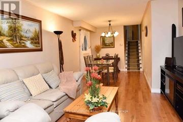 Mississauga (Erin Mills) house for rent - A living room with a couch, coffee table, and a painting on the wall.