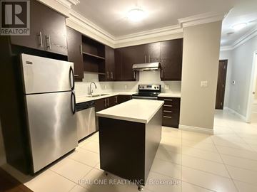 Markham (Commerce Valley) condo for rent - A modern kitchen with dark brown cabinets and stainless steel appliances.